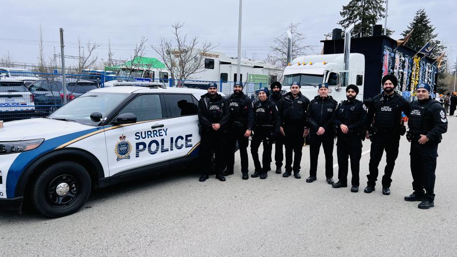 Chief and officer standing outside of a vehicle