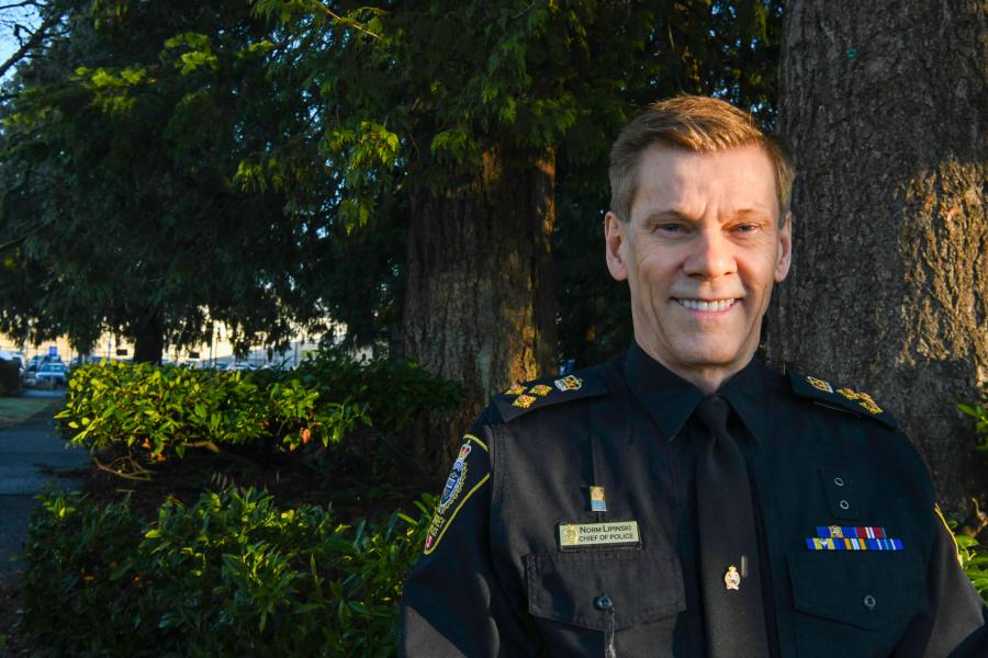 Chief standing in front of trees