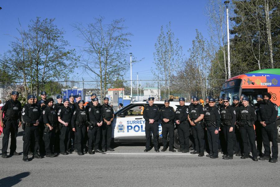 Group standing near vehicle in Vaisakhi parade