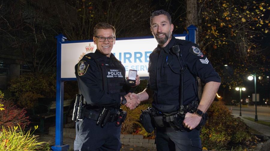 Chief Lipinski shaking hands with Sgt. Phillips